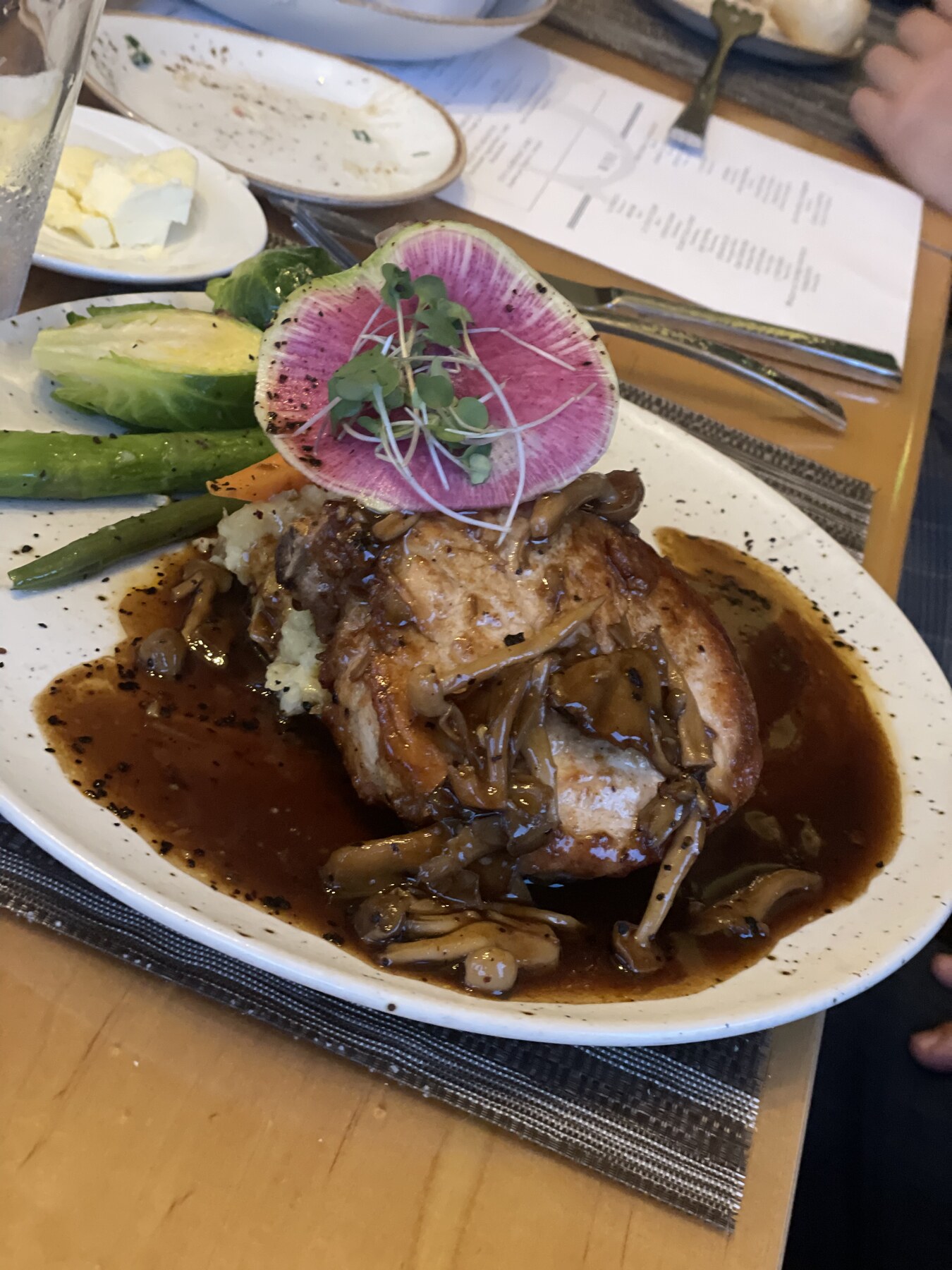 Braised signature dish finished with a vivid edible flower