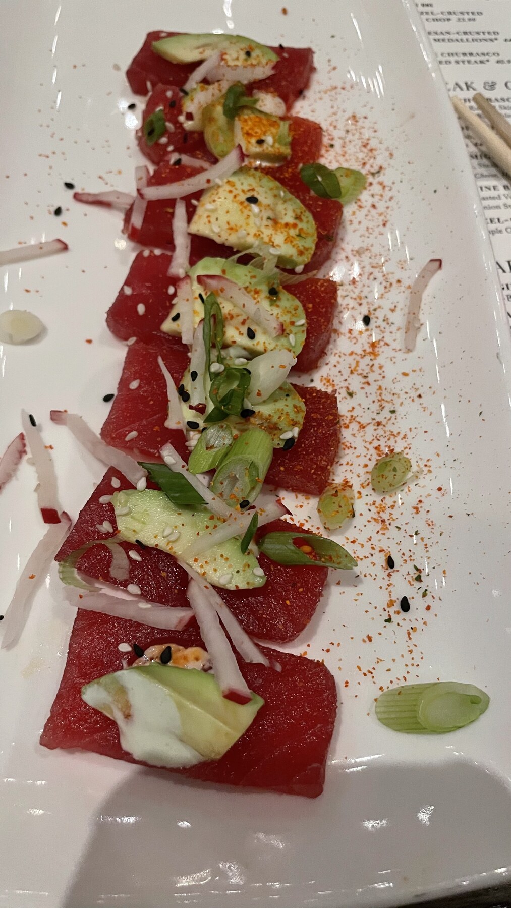Refined carpaccio arranged with greens and delicate garnishes