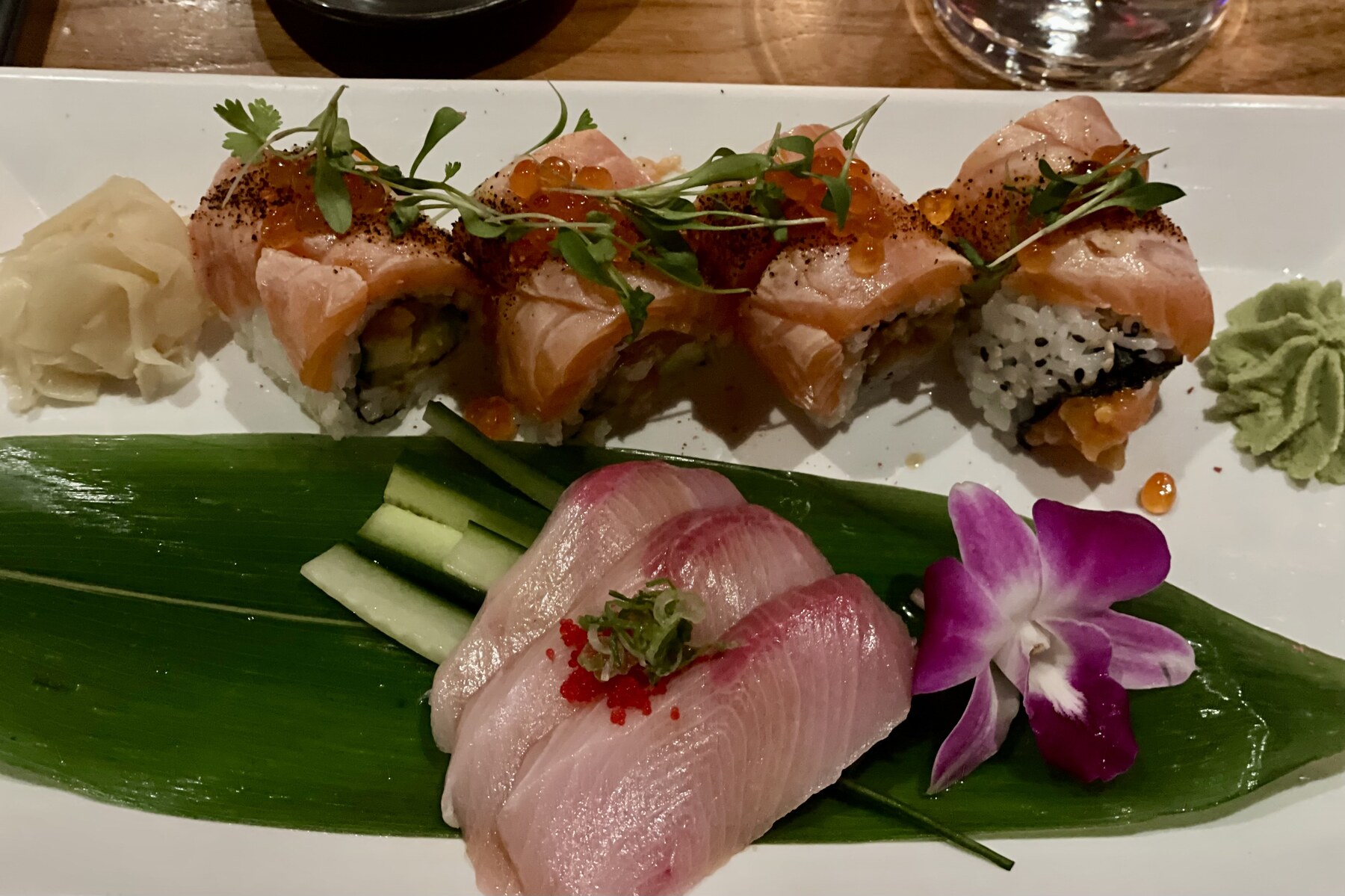 Sushi and sashimi presentation accented with orchids