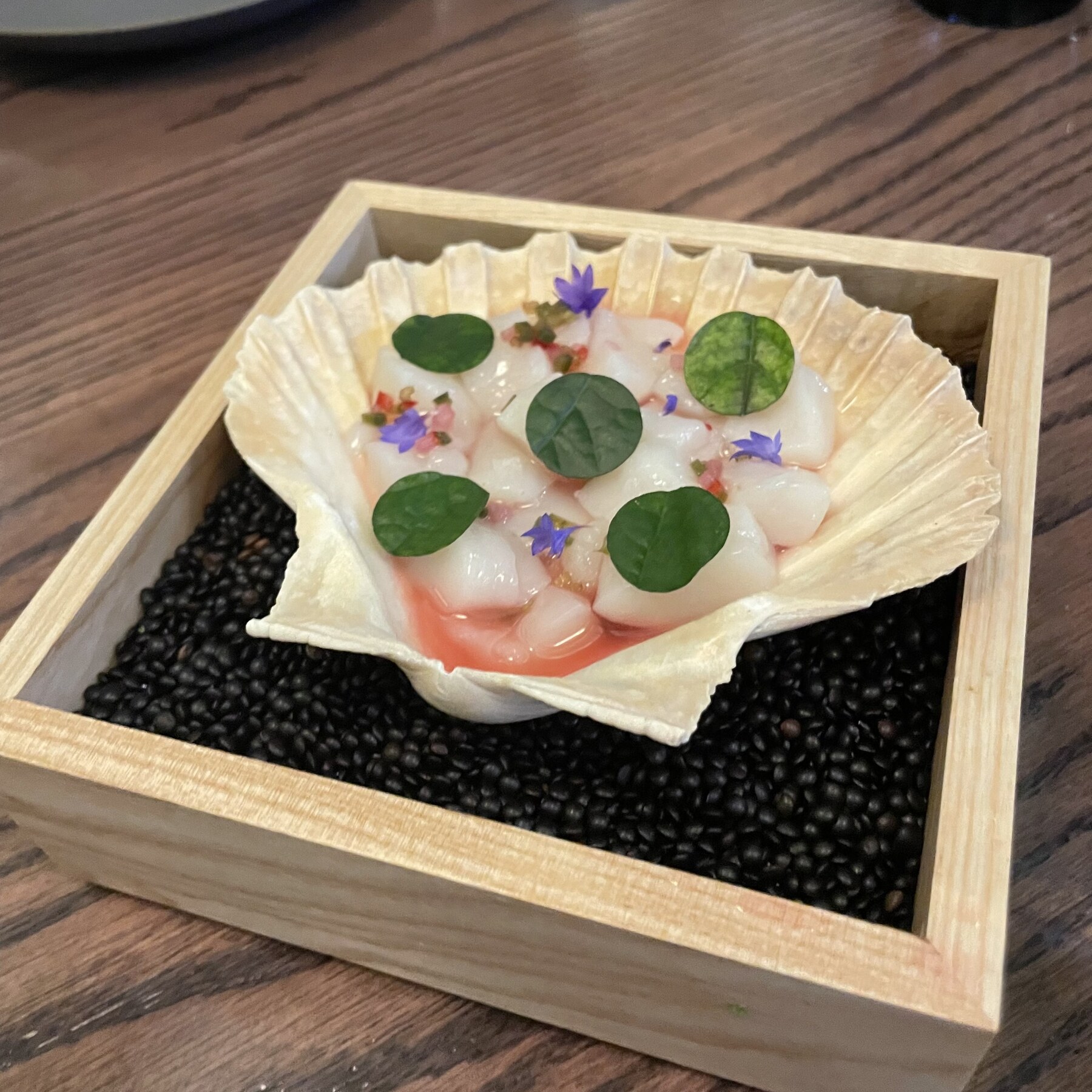 Minimalist tasting-menu course served in a presentation box